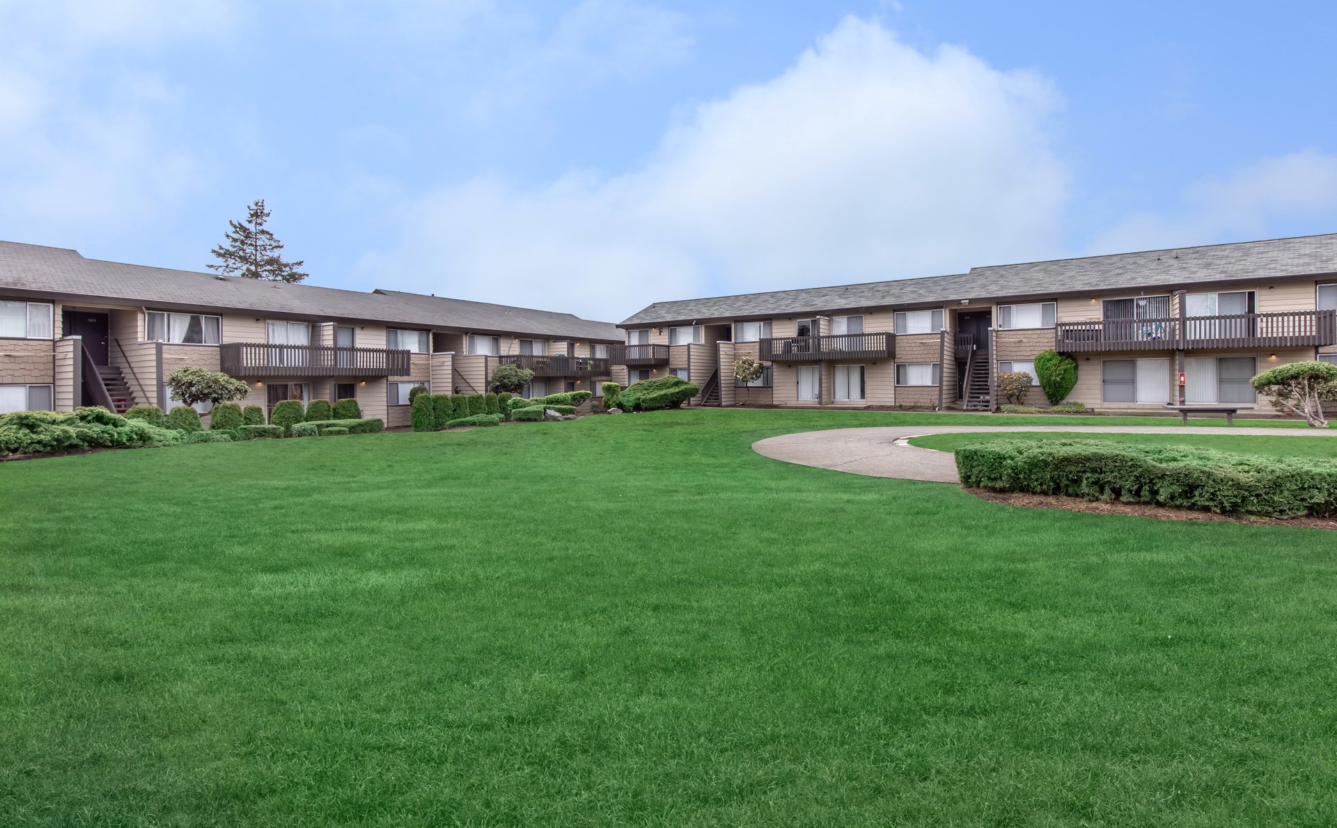 a large green field in front of a building