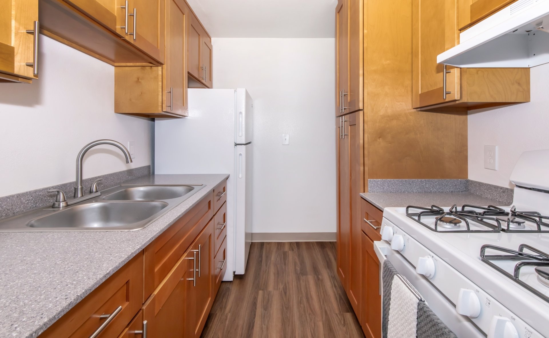 a kitchen with a stove sink and refrigerator