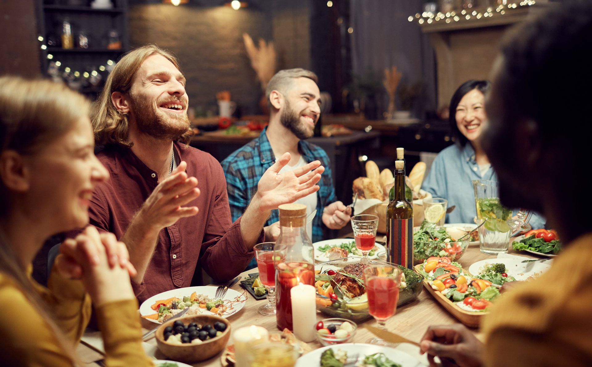 a group of people sitting at a table eating food