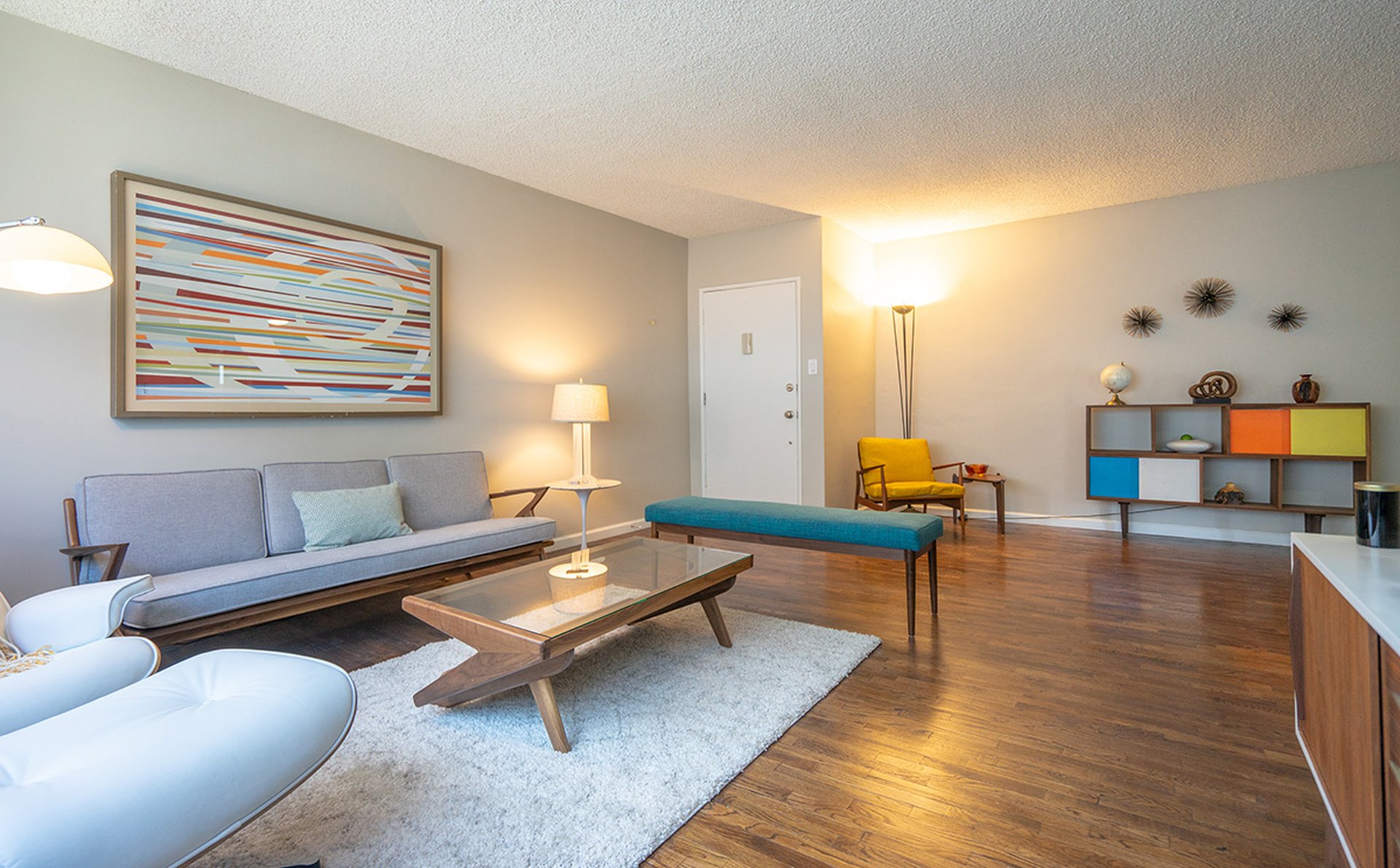 a living room filled with furniture and a wood floor