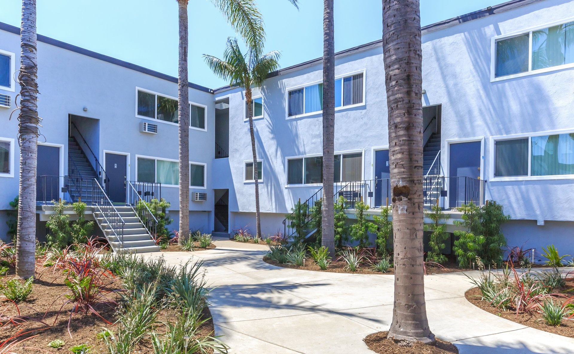 a house with bushes in front of a building