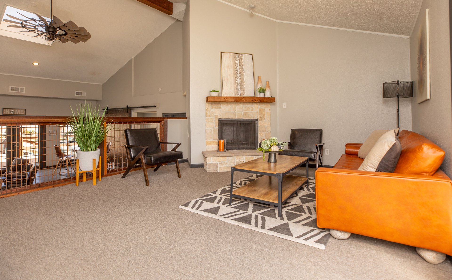 a living room filled with furniture and a fireplace