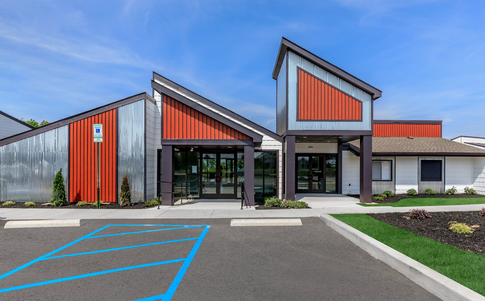 a house that has a sign on the side of a road