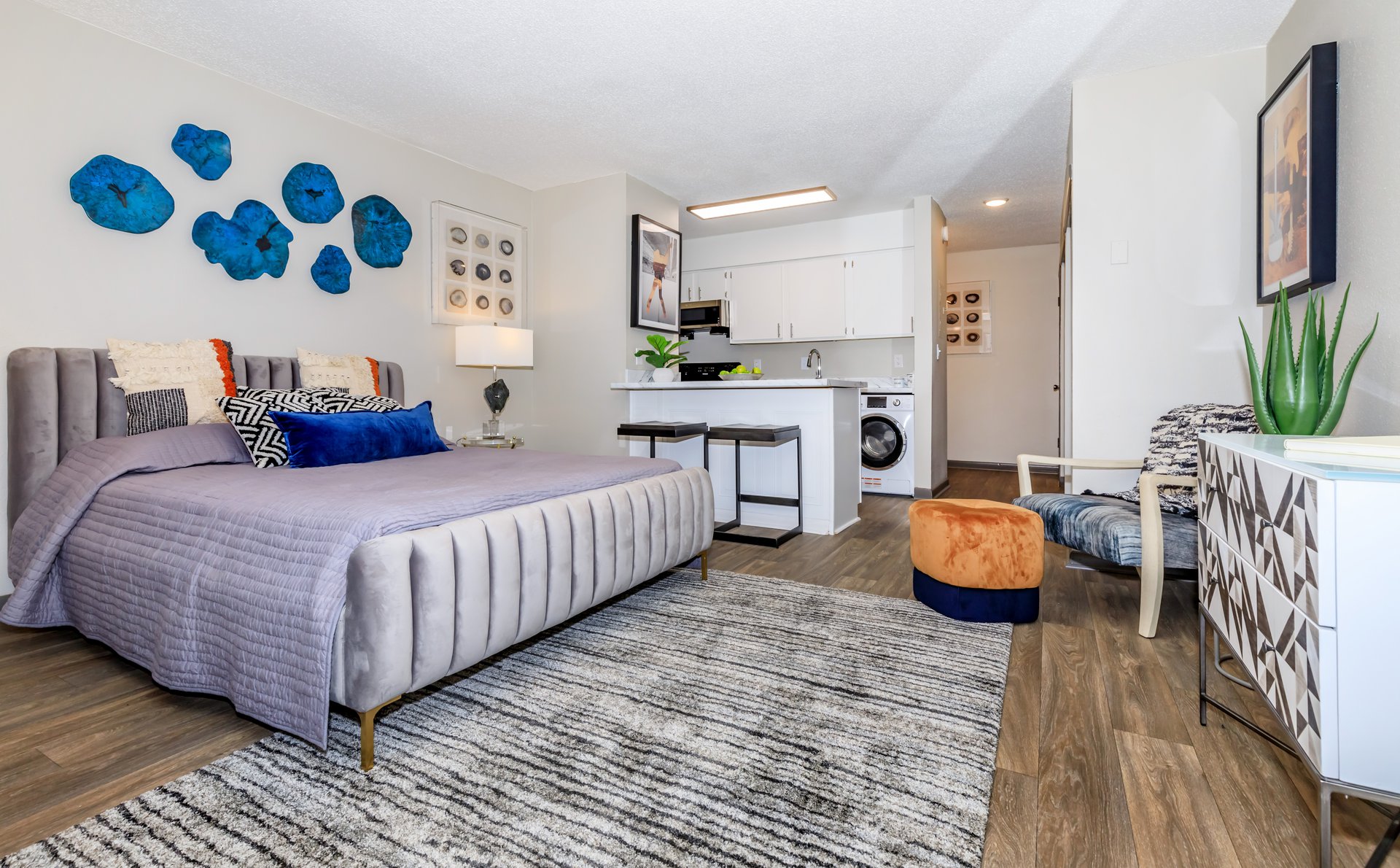 a bedroom with a bed and desk in a room