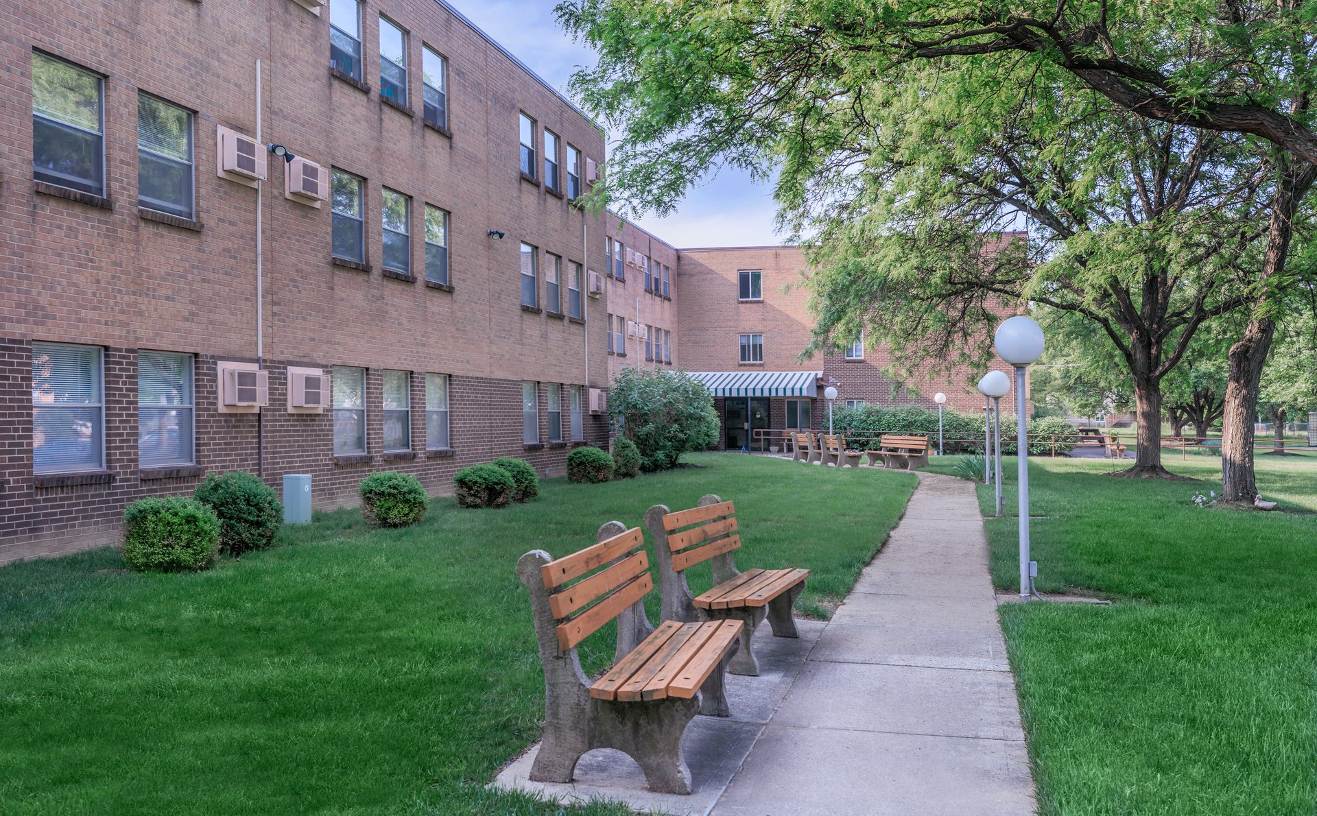 a bench in front of a brick building