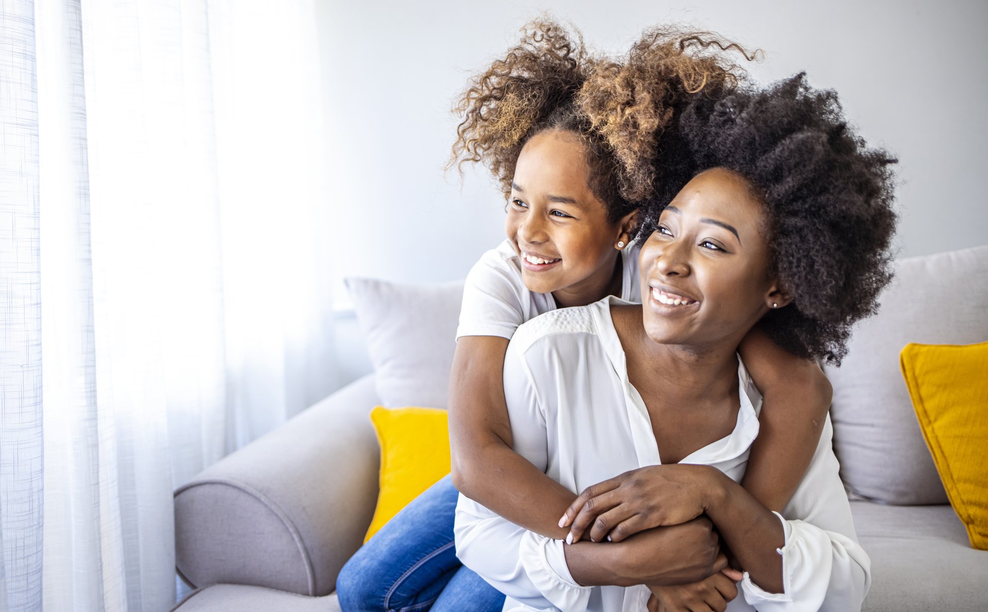 mother and daughter hanging out on couch